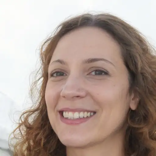 Photo of a smiling woman in her 20s, of white ethnicity, holding the stylish evening bag.