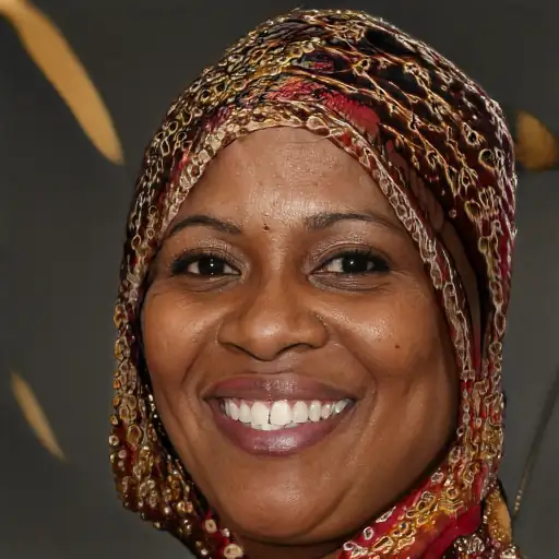 Photo of a woman in her 30s, of Black ethnicity, smiling and holding the bag.
