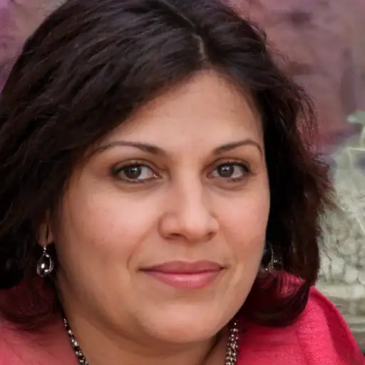 An Indian woman in her 30s with a clear, transformed complexion.