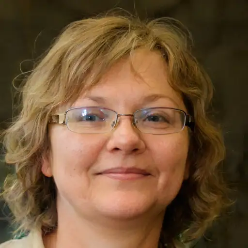 A middle-aged white woman smiling.