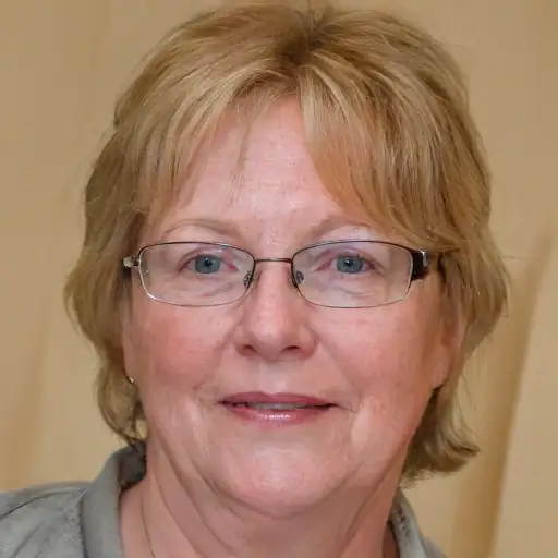 Elderly woman with glasses smiling