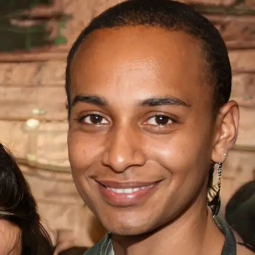 A young Black man in his 20s with healthy, rejuvenated skin.