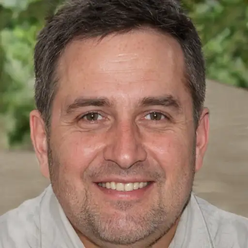 A satisfied white man in his 30s, pointing to his refined pores.