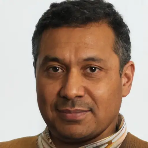 An Indian man in his 40s with visibly improved skin texture.