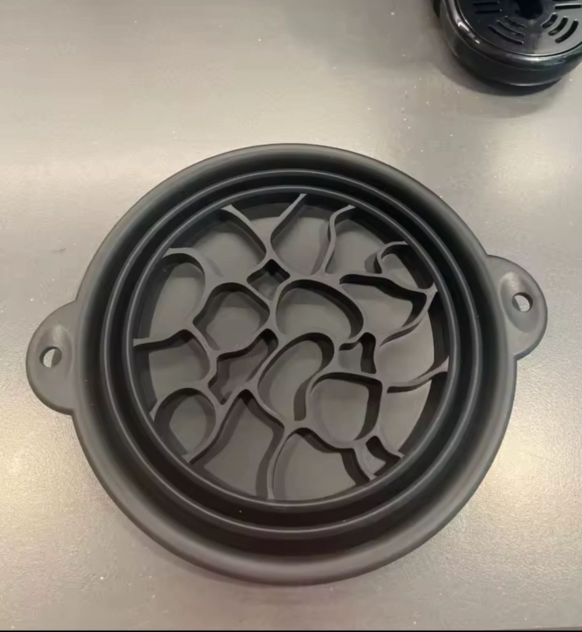 A traveler using a foldable ice bath bowl in a cozy hotel room.