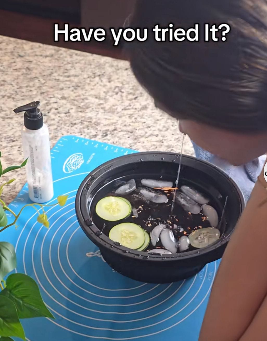 A foldable ice bath bowl being used outdoors for a refreshing facial.