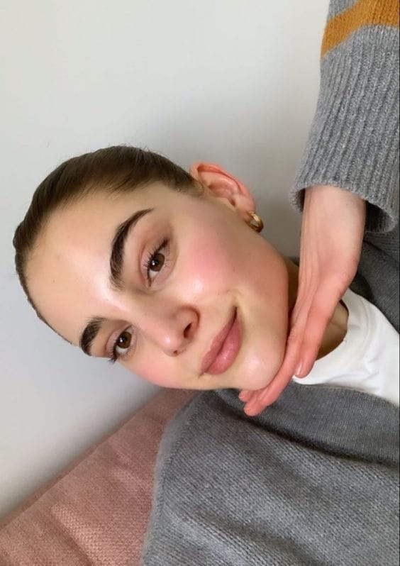 Image of a satisfied customer holding the Dr. Melax Peel Shot ampoule.