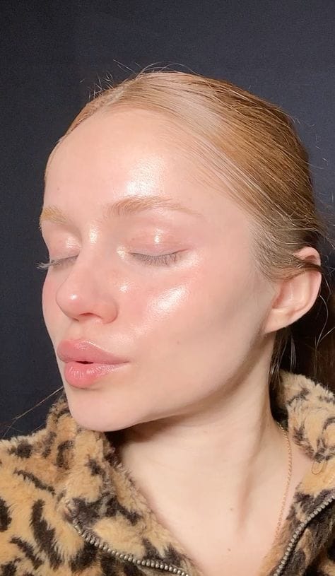 Model with clear, radiant skin showcasing the Anua Heartleaf collection