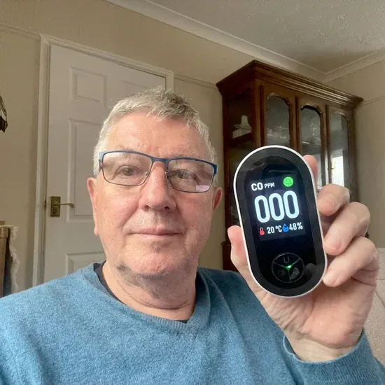 Dog looking happy near a smoke detector