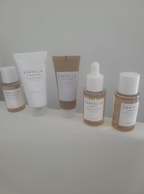 Man applying toner from the SKIN1004 travel kit