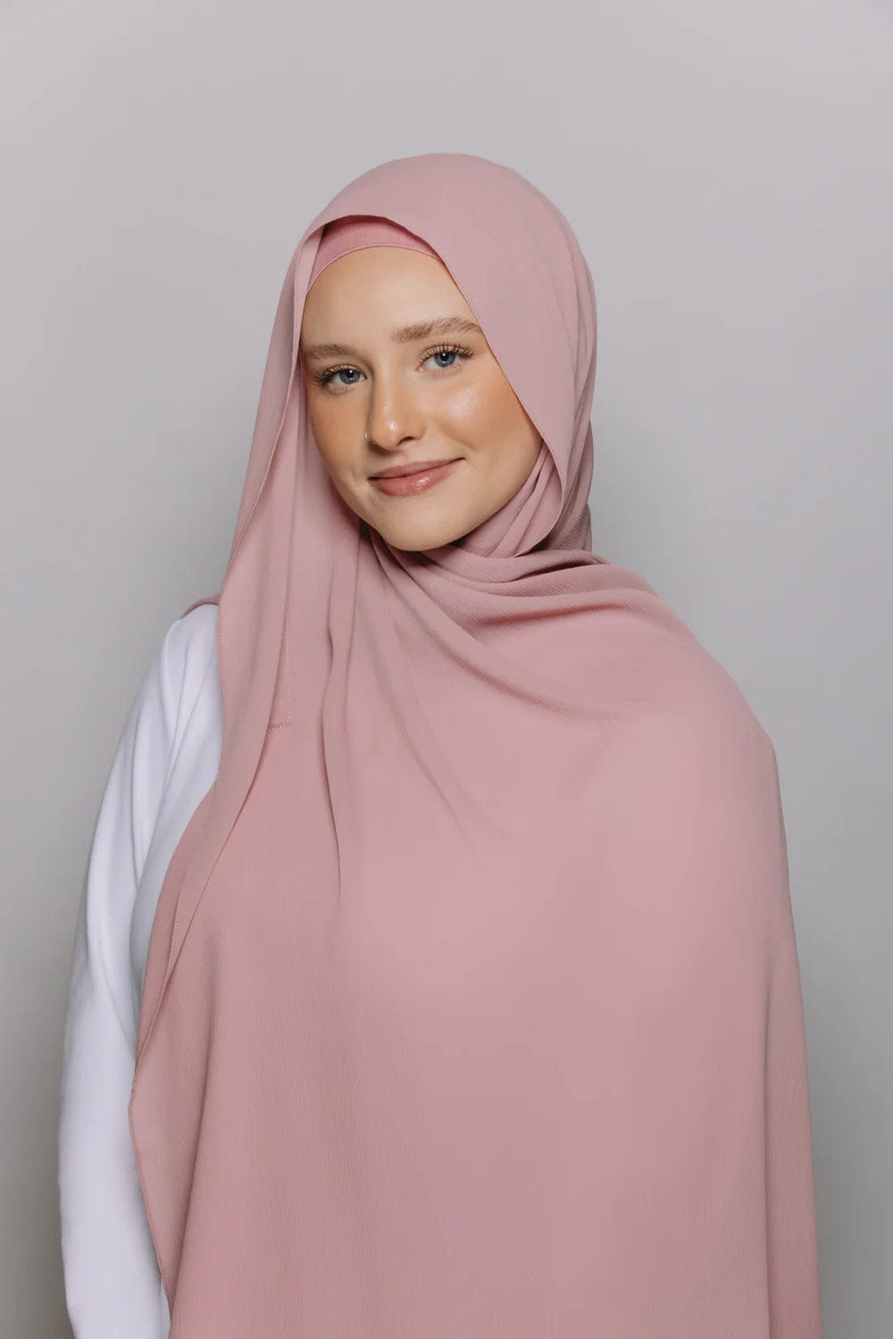 Woman confidently wearing a beautiful instant chiffon hijab with built-in magnets.