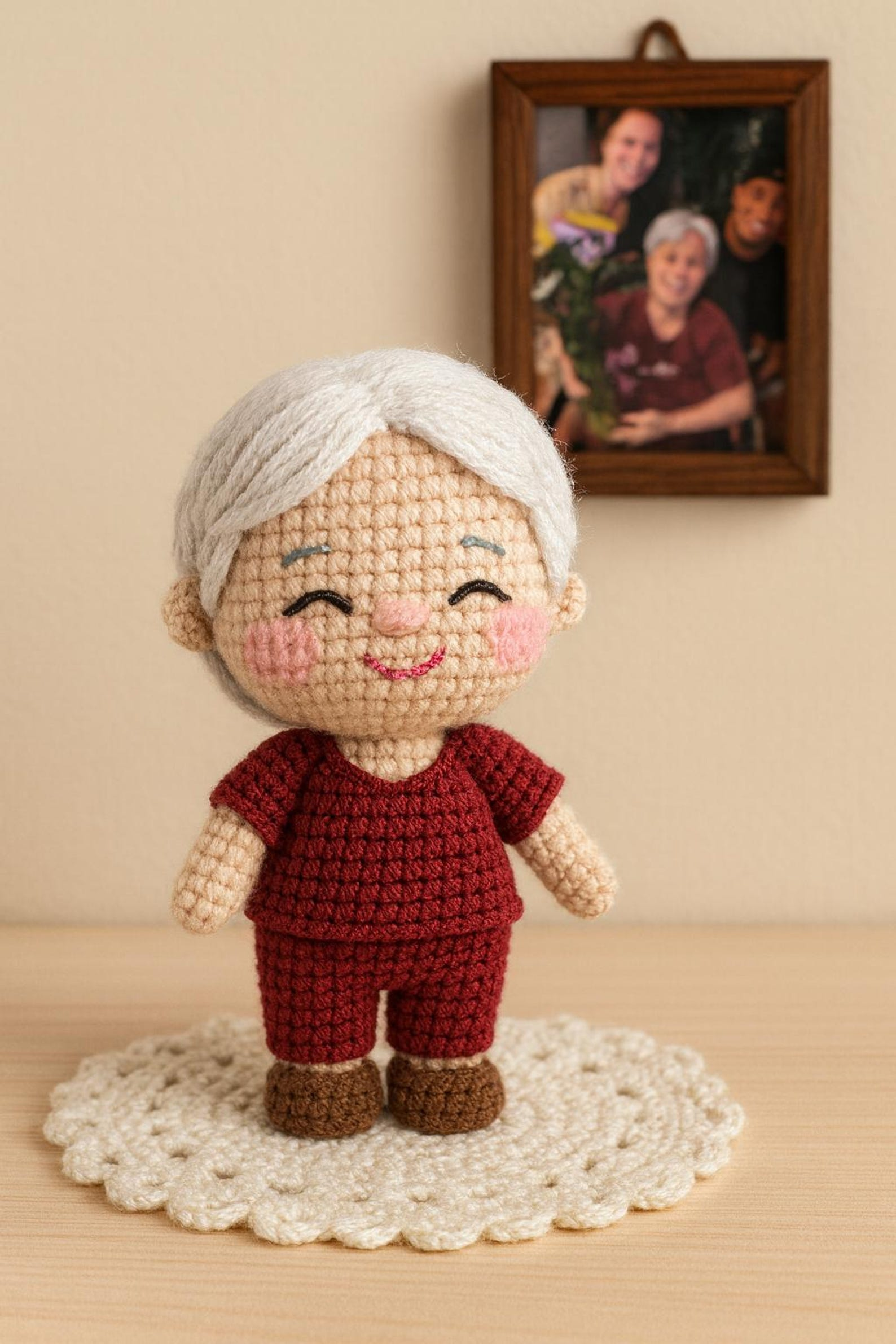 A smiling person holding a custom crochet doll that resembles them