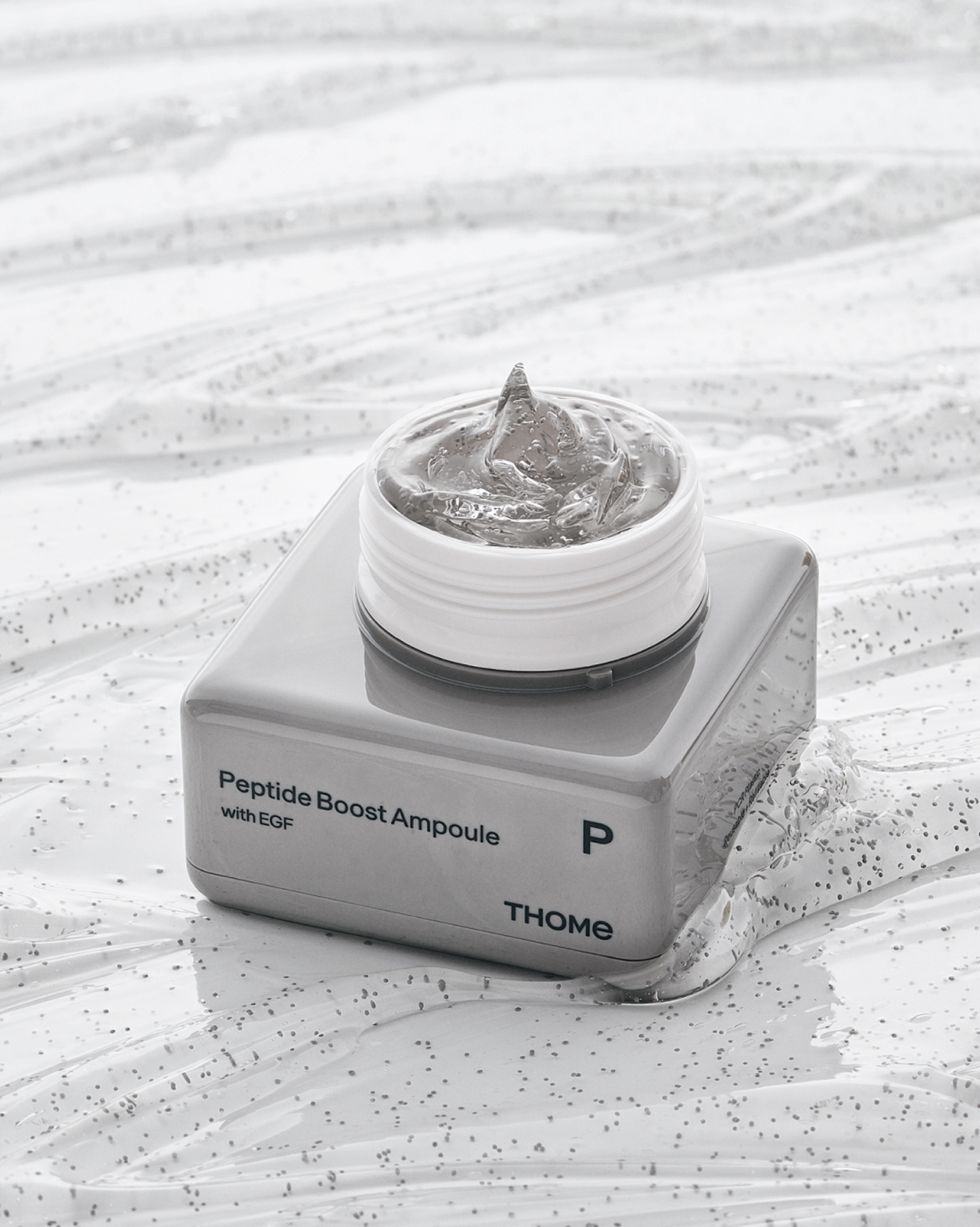 A hand gracefully applying a luxurious serum to the face, highlighting the application process.