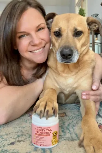 Image of a dog owner holding their pet