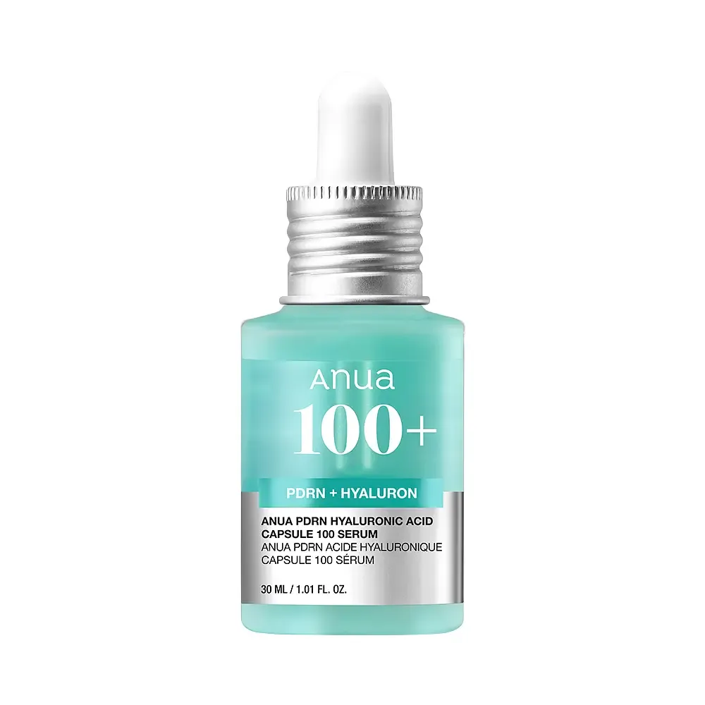 Woman with glowing, hydrated glass skin holding the Anua PDRN Hyaluronic Acid Capsule Serum