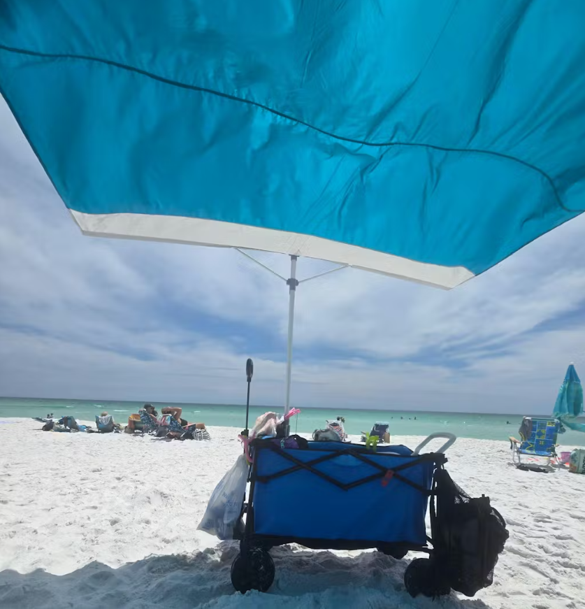 Satisfied customer relaxing under the Solbello umbrella on a sunny beach.