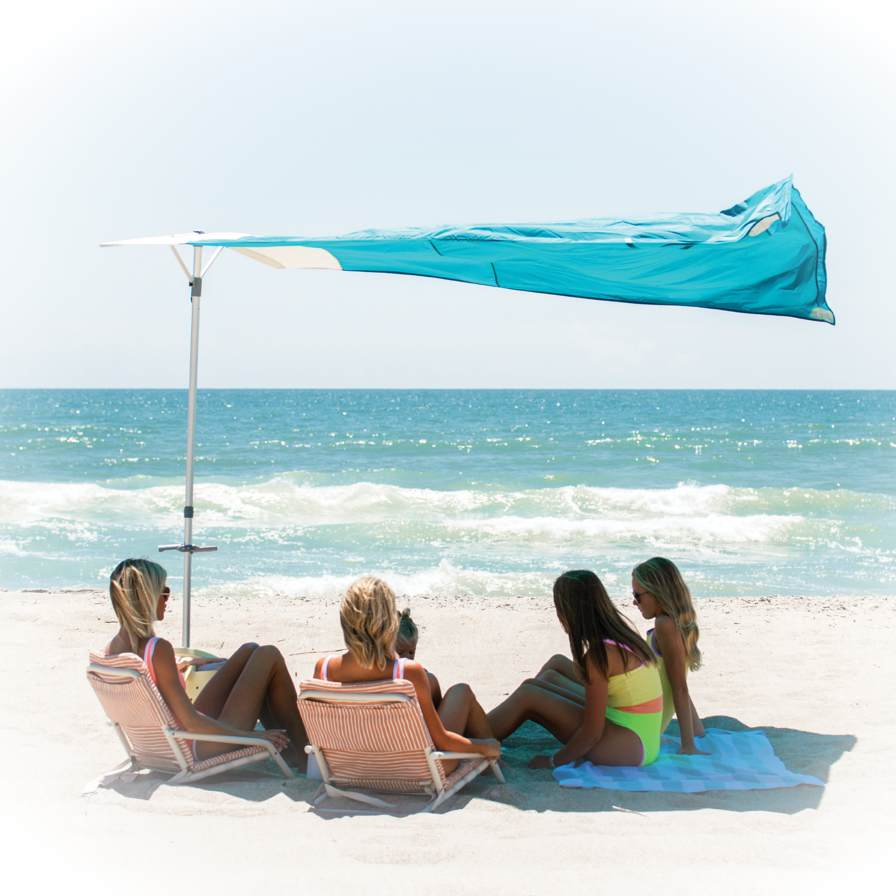 Solbello beach umbrella providing shade on a windy beach.