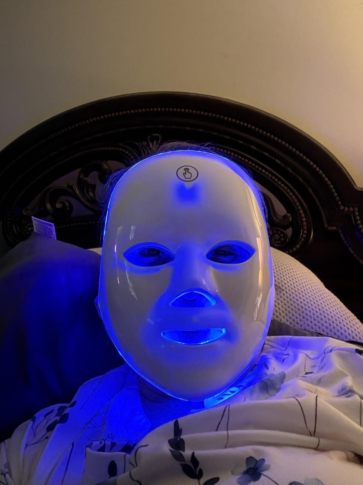 Woman relaxing with the LED mask on her face
