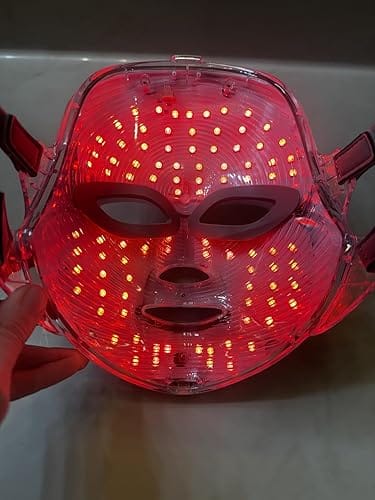 Close-up of a woman smiling while wearing the LED mask