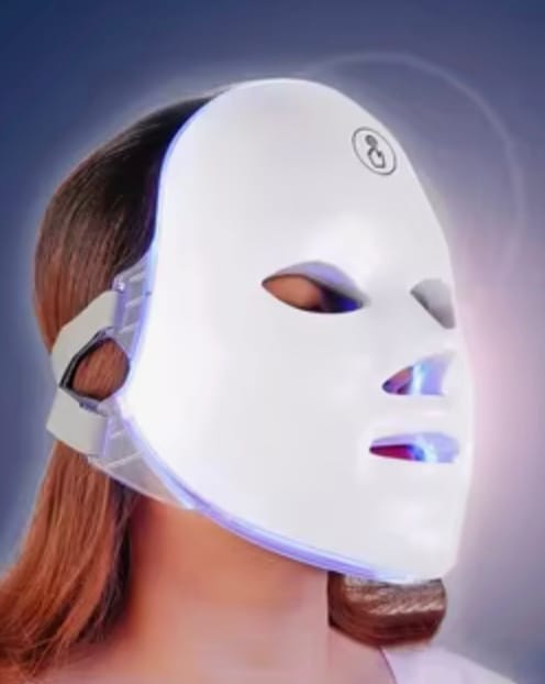 Hand selecting a color on the LED face mask