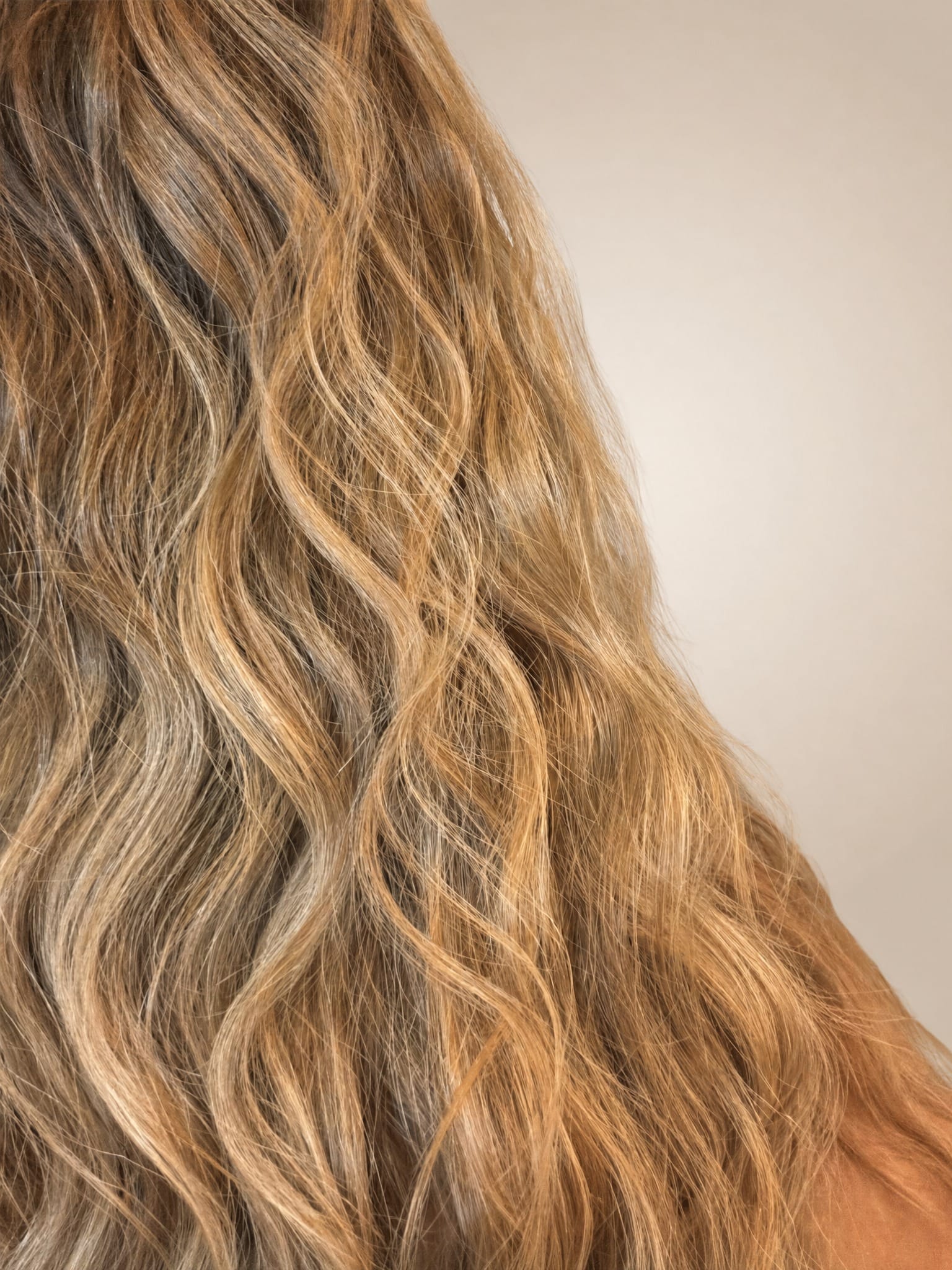 Close up of HaloWave three barrel ceramic styling tool in pink