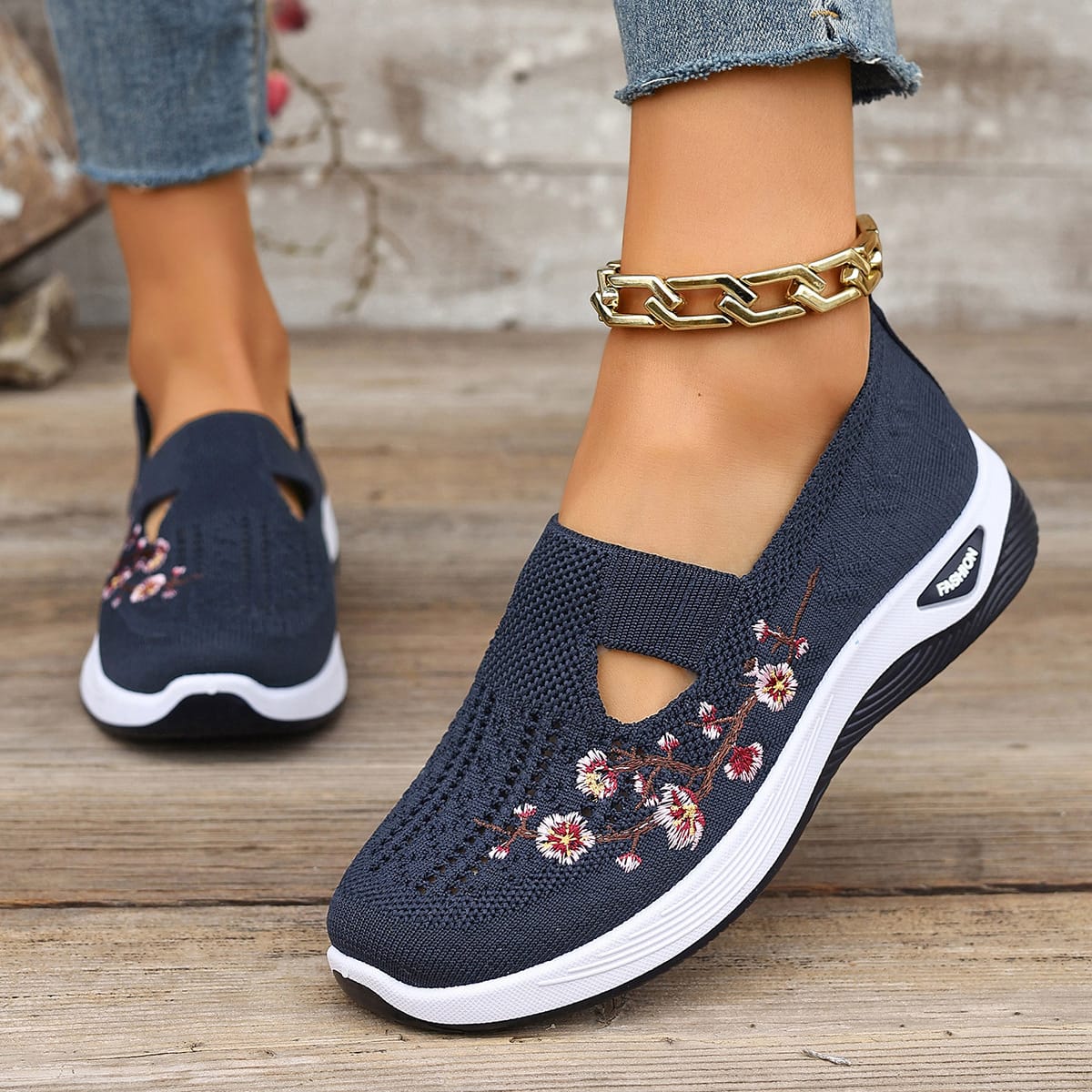 Close up of floral embroidered wedge shoes on a model