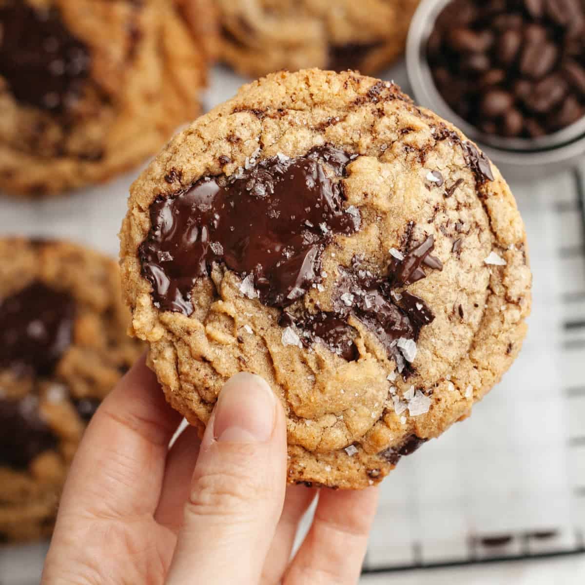 Freshly baked chocolate chip cookies on cooling rack