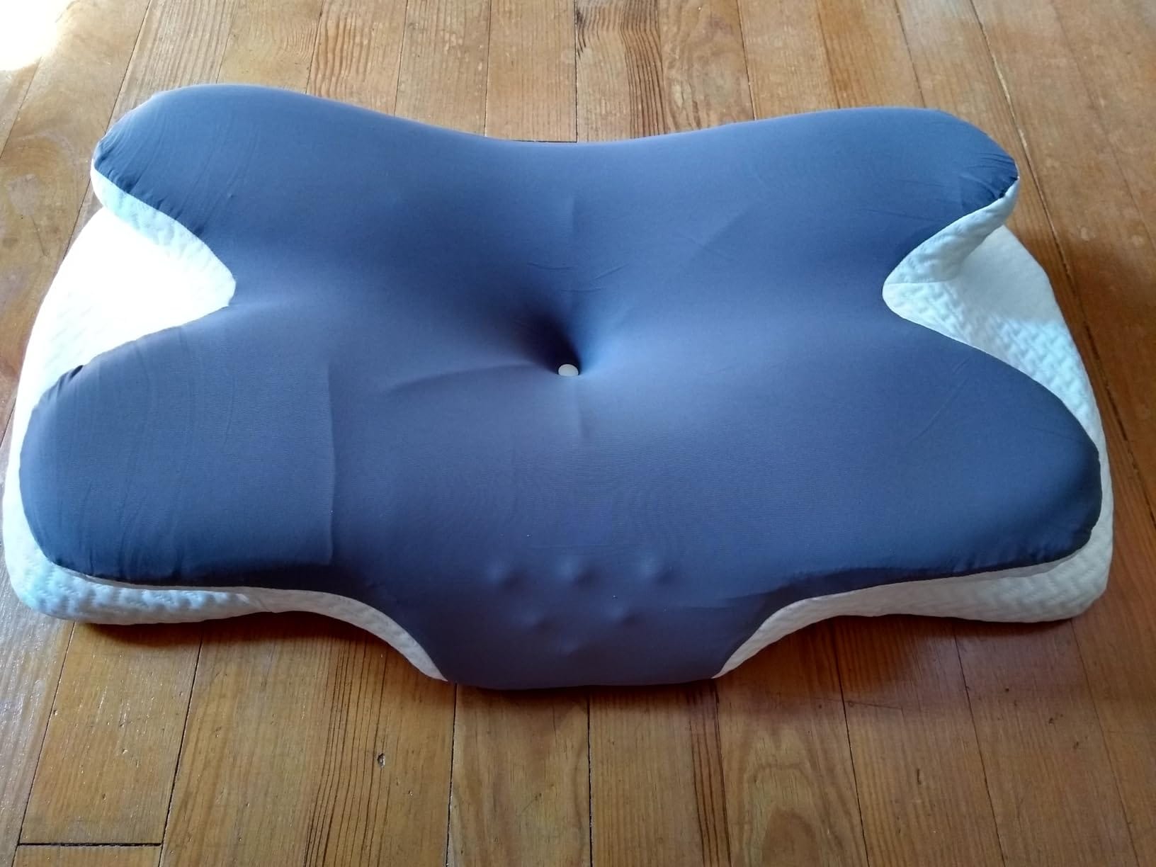Happy woman sleeping on ergonomic memory foam pillow
