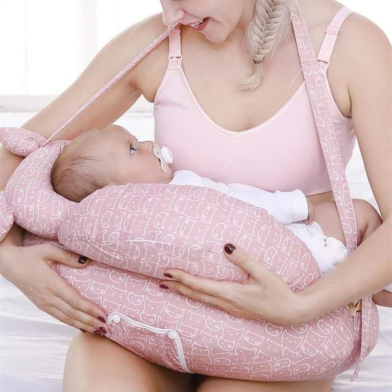 Happy mother using the Cuddle Nest Pillow for breastfeeding