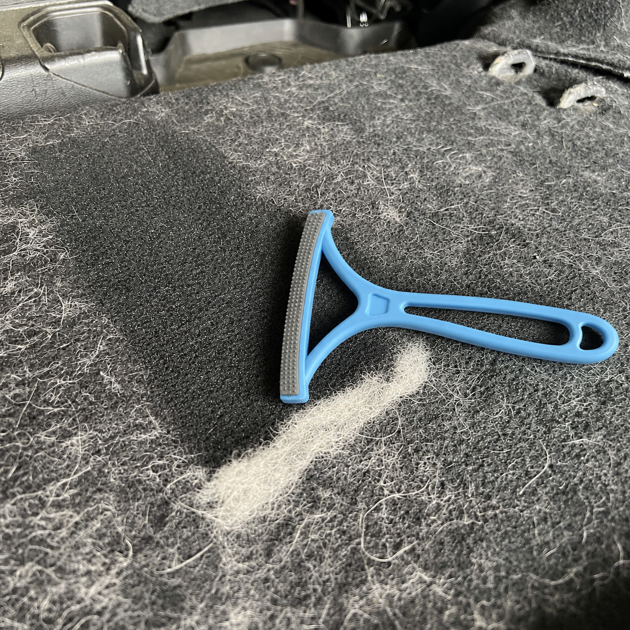 Pet hair remover tool cleaning sofa