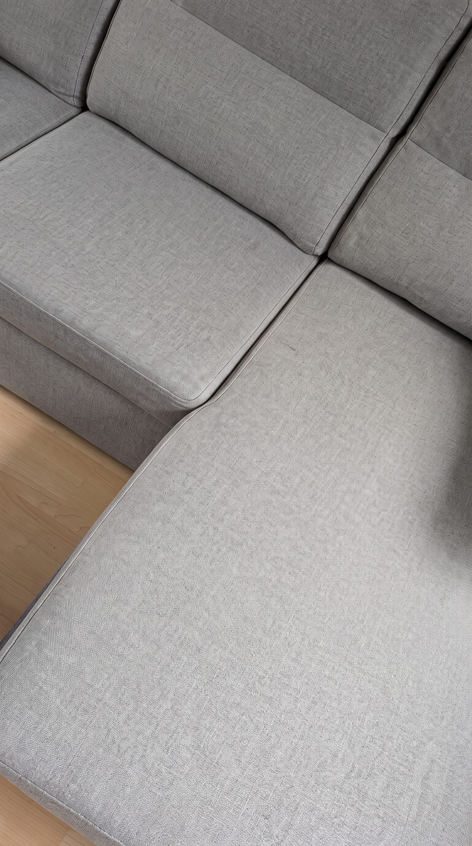 Satisfied customer using hair remover on sofa