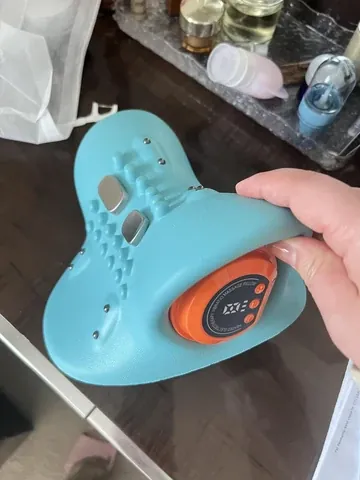 Man enjoying neck pillow with remote